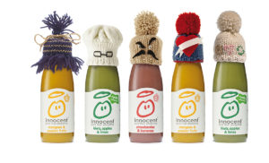 Photograph of Innocent drinks wearing beanie hats.